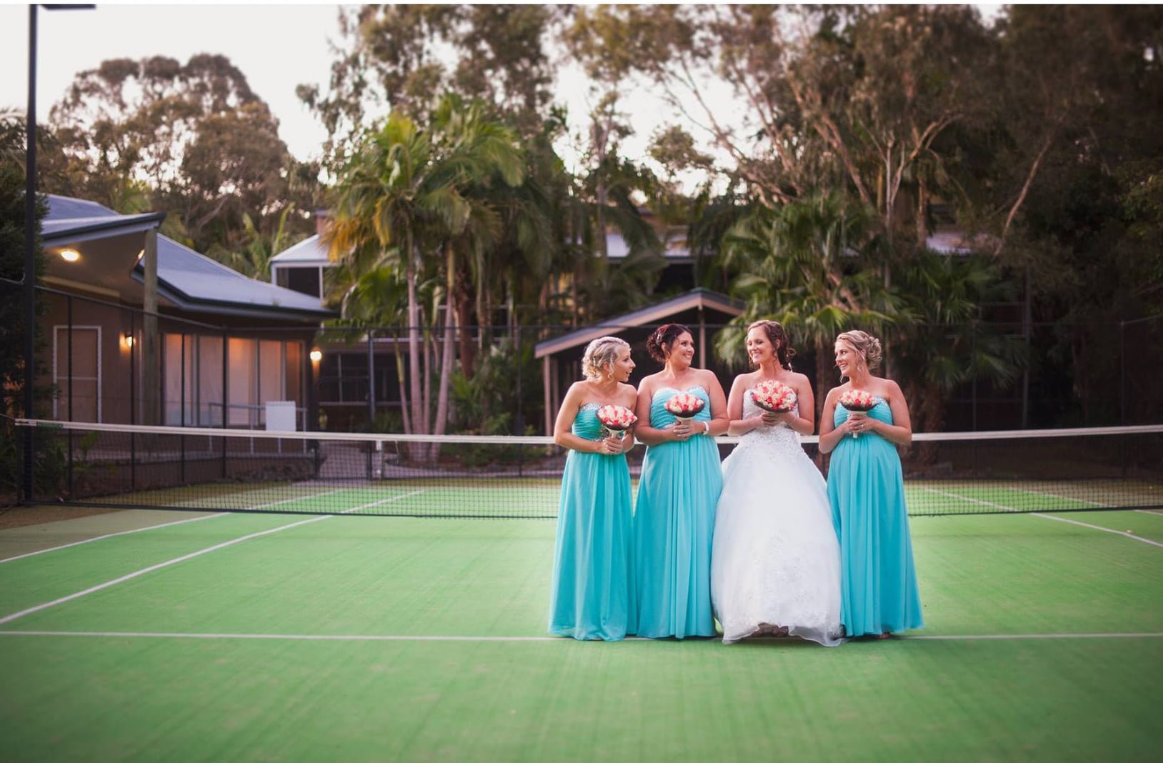 Bridesmaids ona tennis court